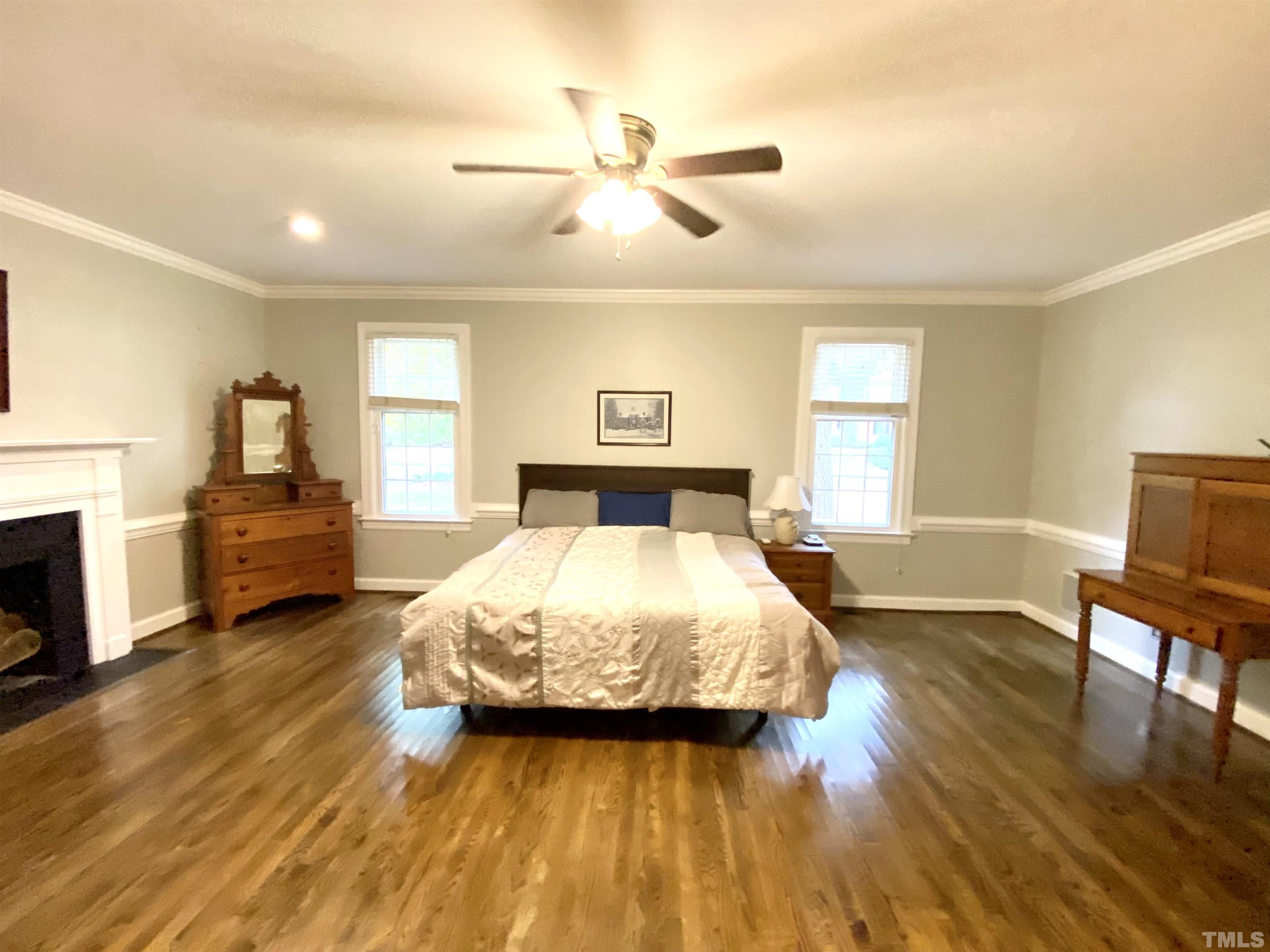 2103 Hermitage Road Northwest Wilson, NC 27896 - Photo 17 of 27 a spacious bedroom with a large bed and a chandelier