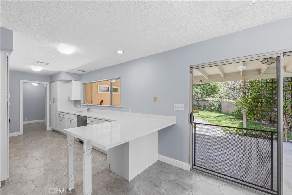 24673 Barton Road Loma Linda, CA 92354 - Photo 11 of 38 a view of kitchen with cabinets and outdoor space