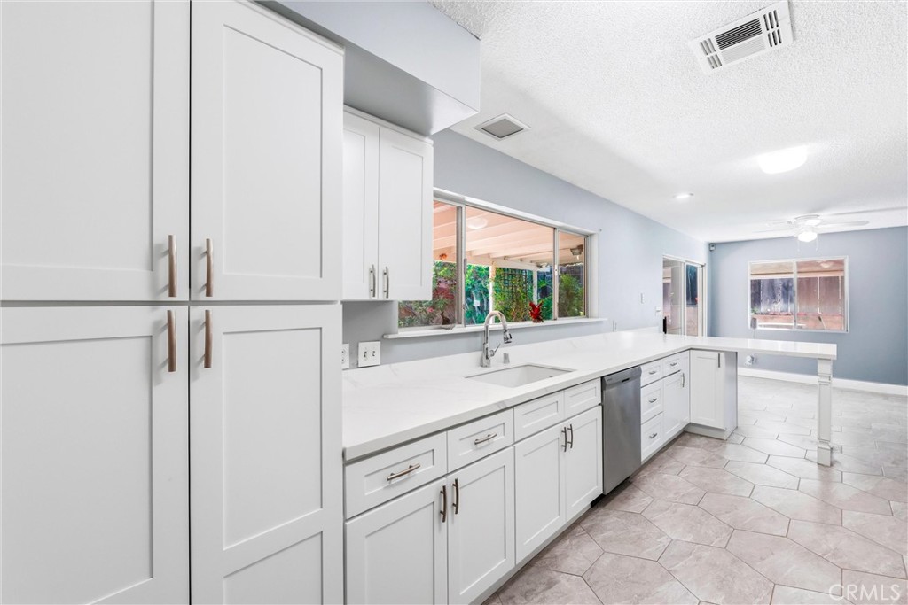 24673 Barton Road Loma Linda, CA 92354 - Photo 12 of 38 a kitchen with a sink and cabinets