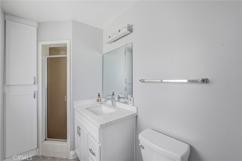 24673 Barton Road Loma Linda, CA 92354 - Photo 20 of 38 a bathroom with a sink a toilet and shower