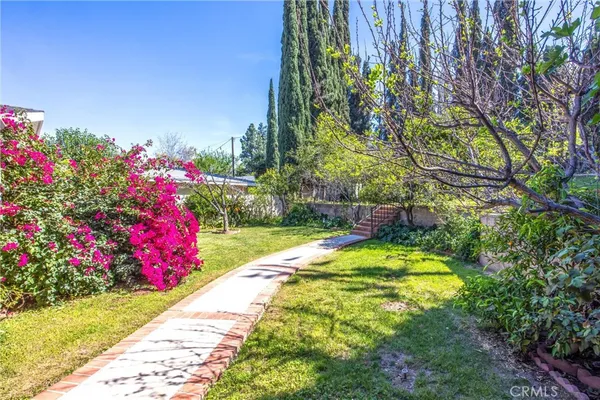 a view of a garden with a building in the background