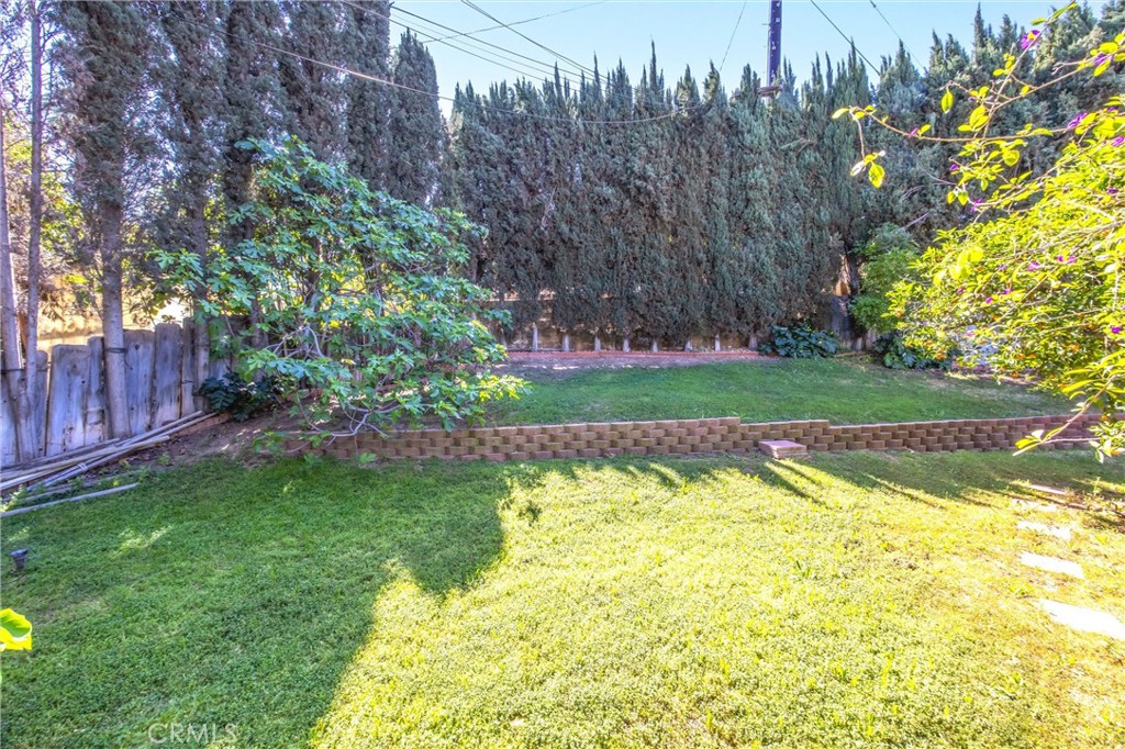 24673 Barton Road Loma Linda, CA 92354 - Photo 33 of 38 a view of a backyard with fountain and large trees