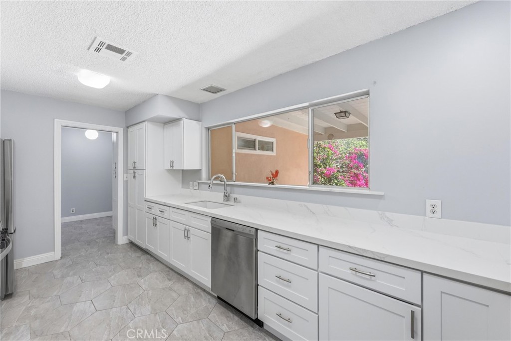 24673 Barton Road Loma Linda, CA 92354 - Photo 8 of 38 a spacious bathroom with a granite countertop sink mirror and double