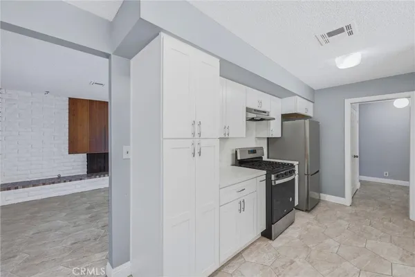 a view of kitchen with cabinets and outdoor space