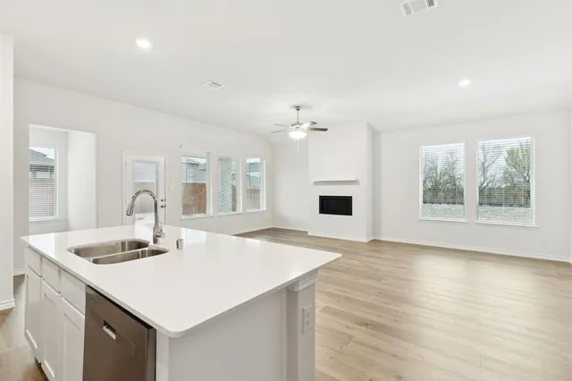 a kitchen with a sink and a stove top oven