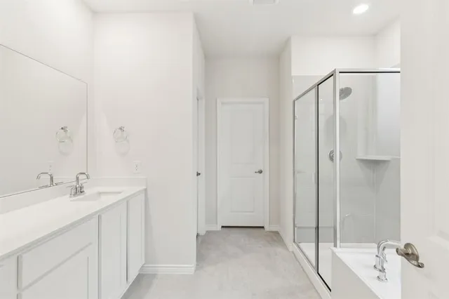 a spacious bathroom with a shower and a sink