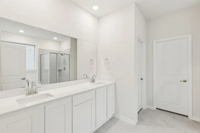 a bathroom with a double vanity sink mirror and