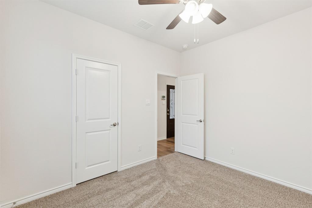 2209 Tacoma Way Anna, TX 75409 - Photo 4 of 29 an empty room with a ceiling fan and a window