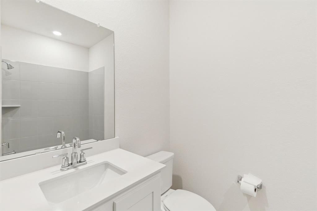 2209 Tacoma Way Anna, TX 75409 - Photo 5 of 29 a bathroom with a sink mirror and toilet