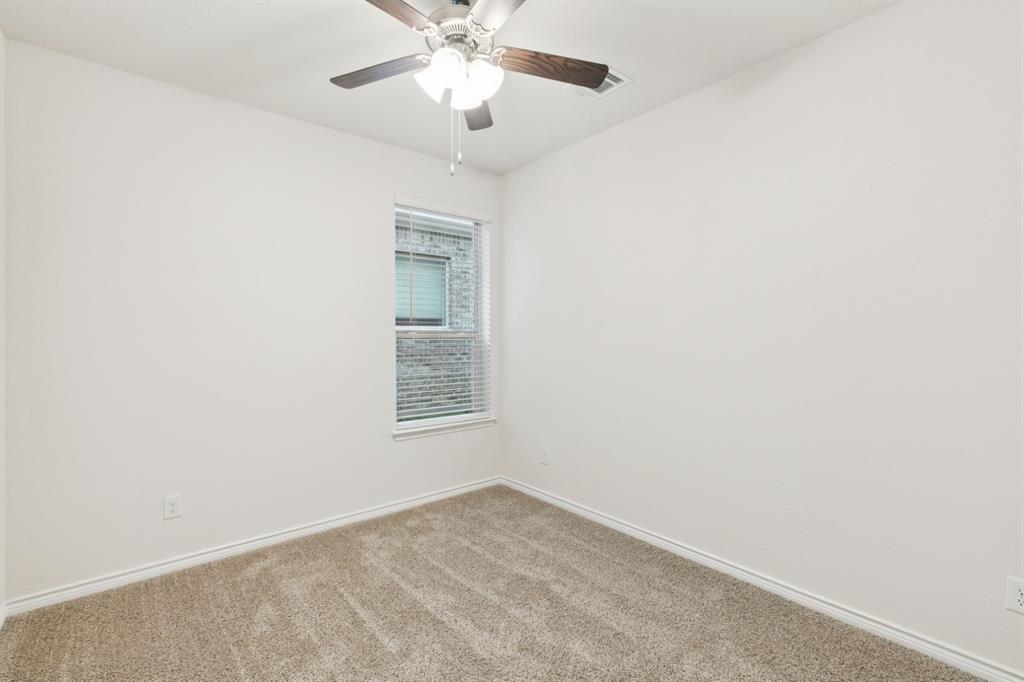 2209 Tacoma Way Anna, TX 75409 - Photo 9 of 29 an empty room with a window and a fan