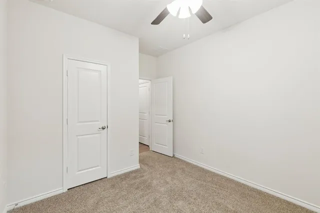 an empty room with a ceiling fan