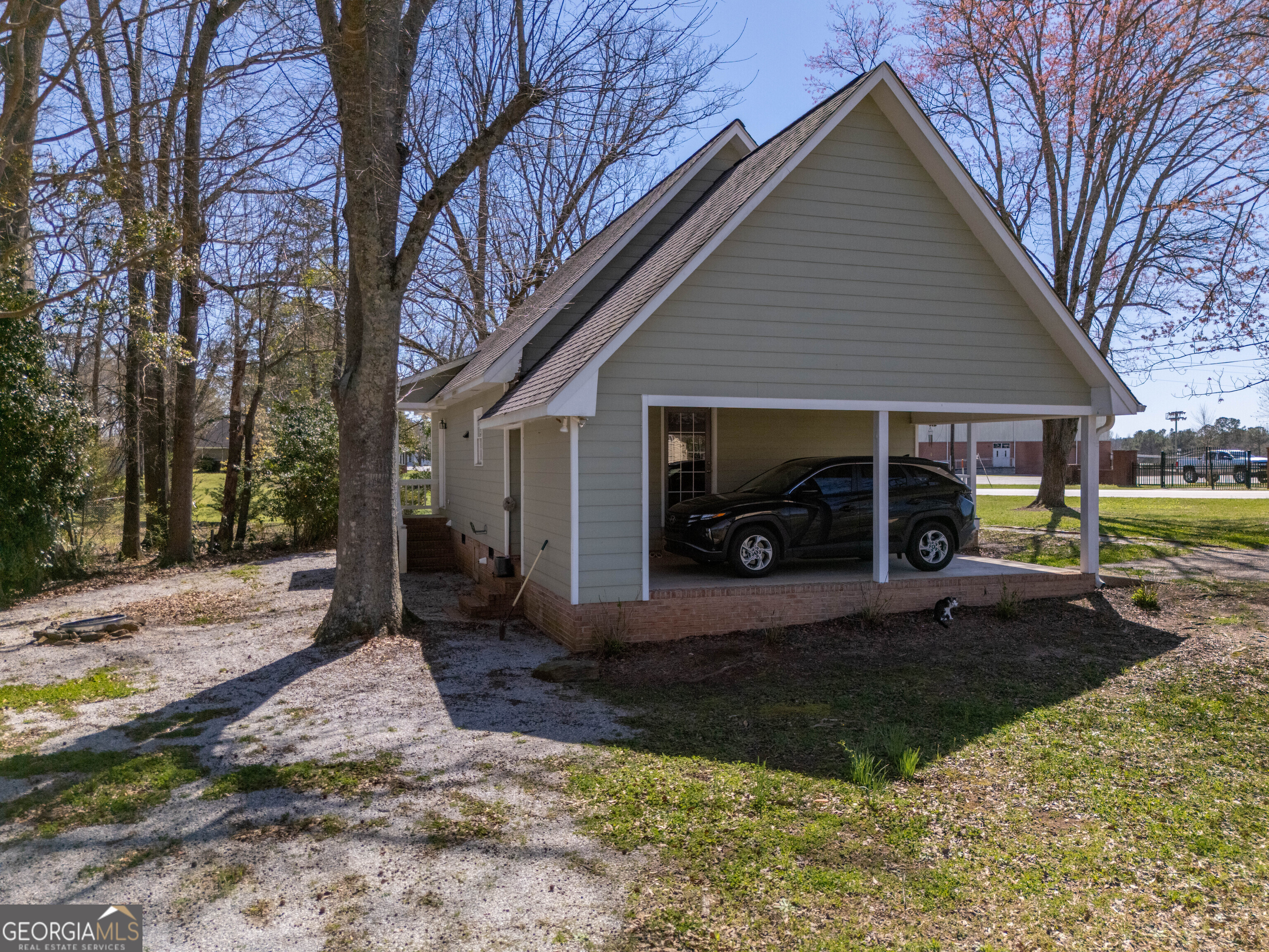 894 Highland Avenue Wadley, AL 36276 - Photo 24 of 26 a front view of a house with garden and trees