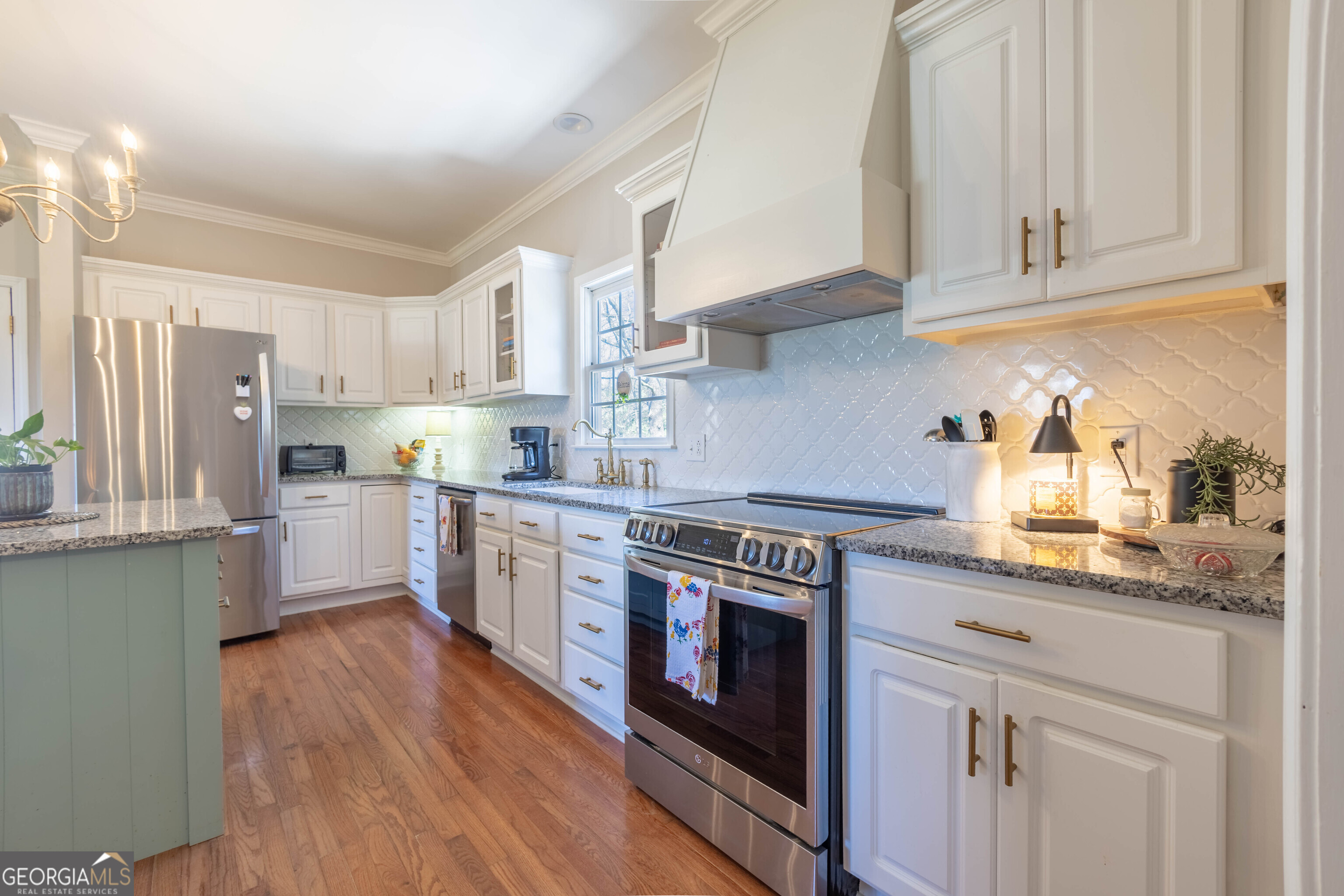 894 Highland Avenue Wadley, AL 36276 - Photo 7 of 26 a kitchen with stainless steel appliances granite countertop a stove a sink dishwasher and a refrigerator with wooden cabinets