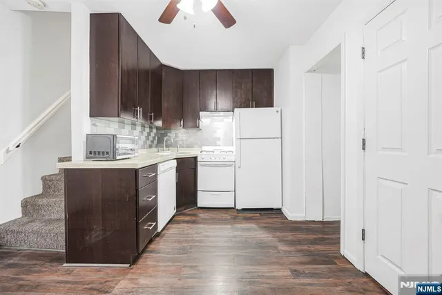 a kitchen with stainless steel appliances a sink a stove a refrigerator and cabinets