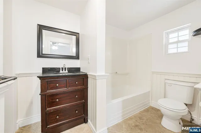 a bathroom with a toilet a sink and bathtub
