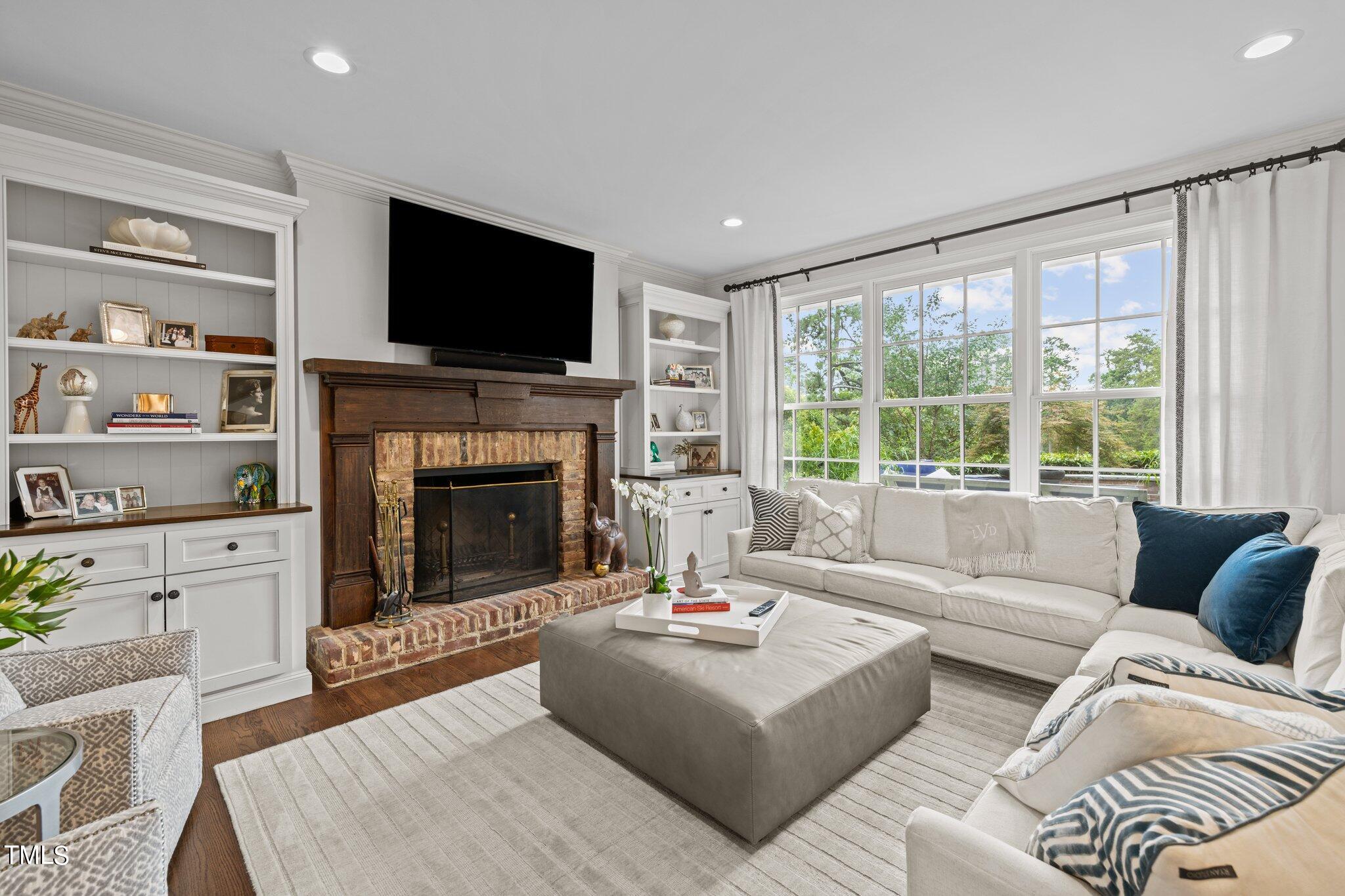 3125 Cornwall Road Durham, NC 27707 - Photo 20 of 99 a living room with furniture a flat screen tv and a fireplace