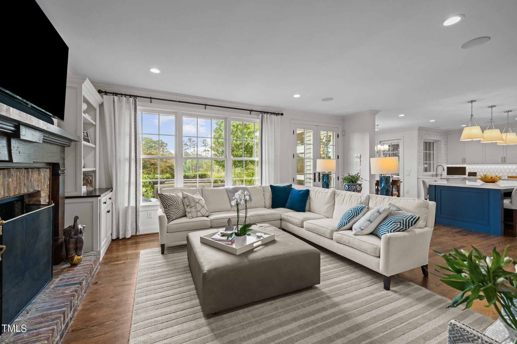3125 Cornwall Road Durham, NC 27707 - Photo 23 of 99 a living room with fireplace furniture and a flat screen tv