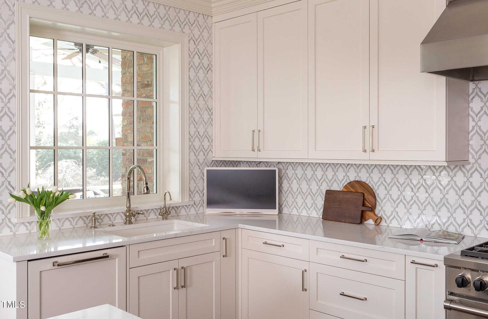 3125 Cornwall Road Durham, NC 27707 - Photo 36 of 99 a kitchen with stainless steel appliances white cabinets and a window