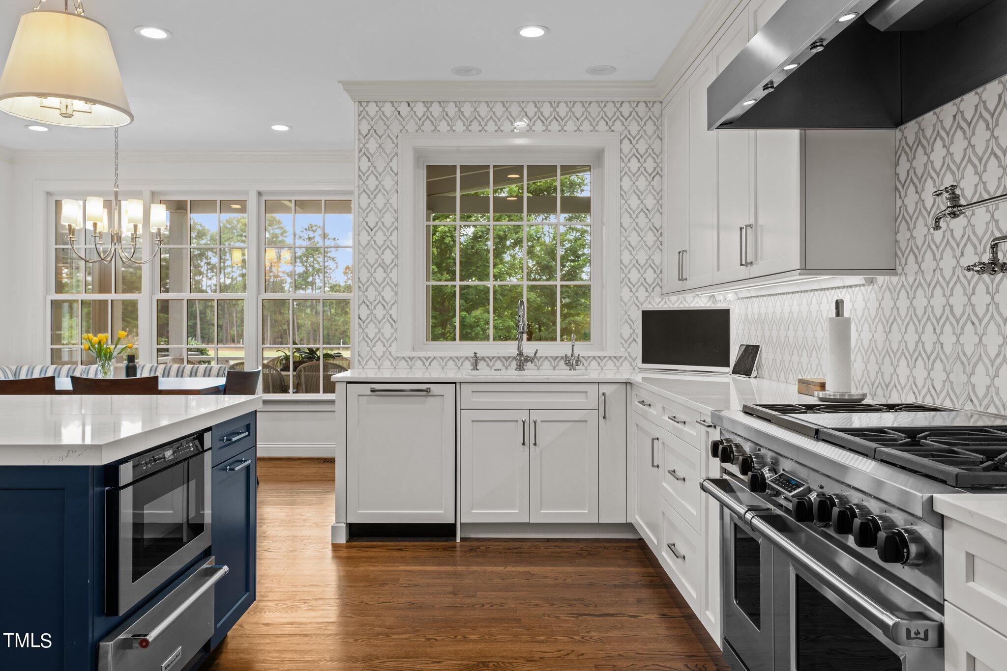 3125 Cornwall Road Durham, NC 27707 - Photo 43 of 99 a kitchen with a stove a sink and a granite counter tops