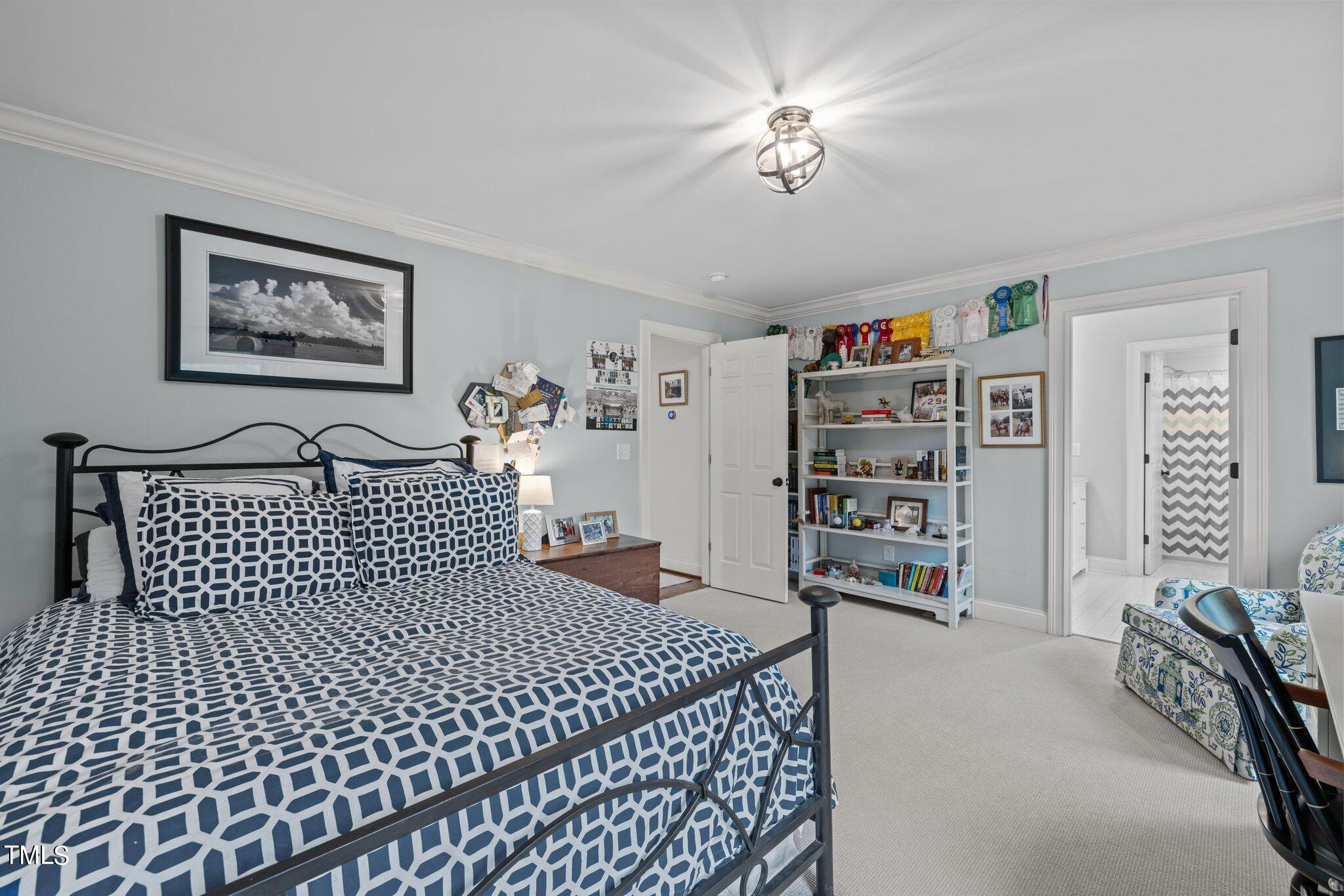 3125 Cornwall Road Durham, NC 27707 - Photo 59 of 99 a bedroom with a bed and a book shelf