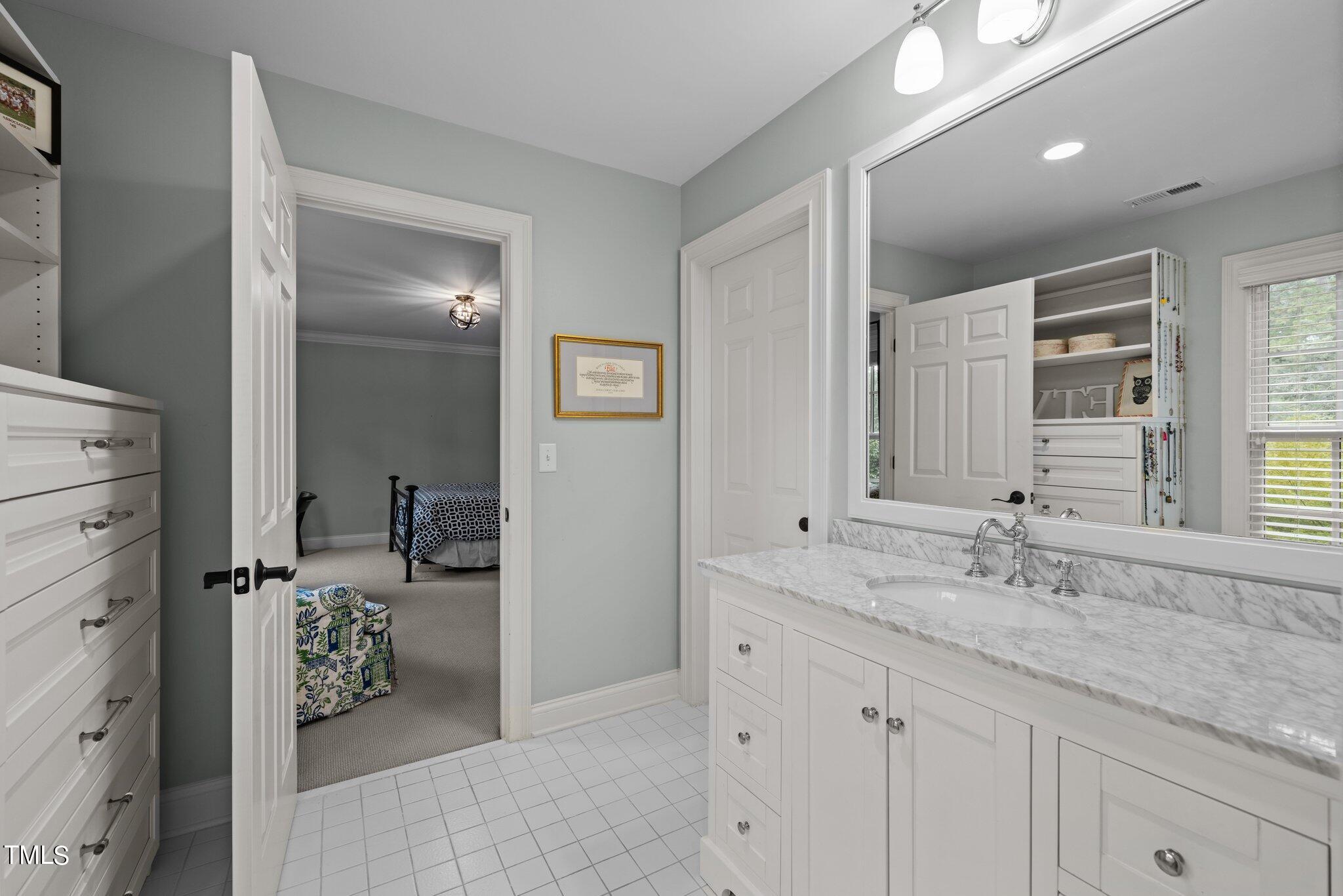 3125 Cornwall Road Durham, NC 27707 - Photo 61 of 99 a en suite bathroom with double sink and a mirror