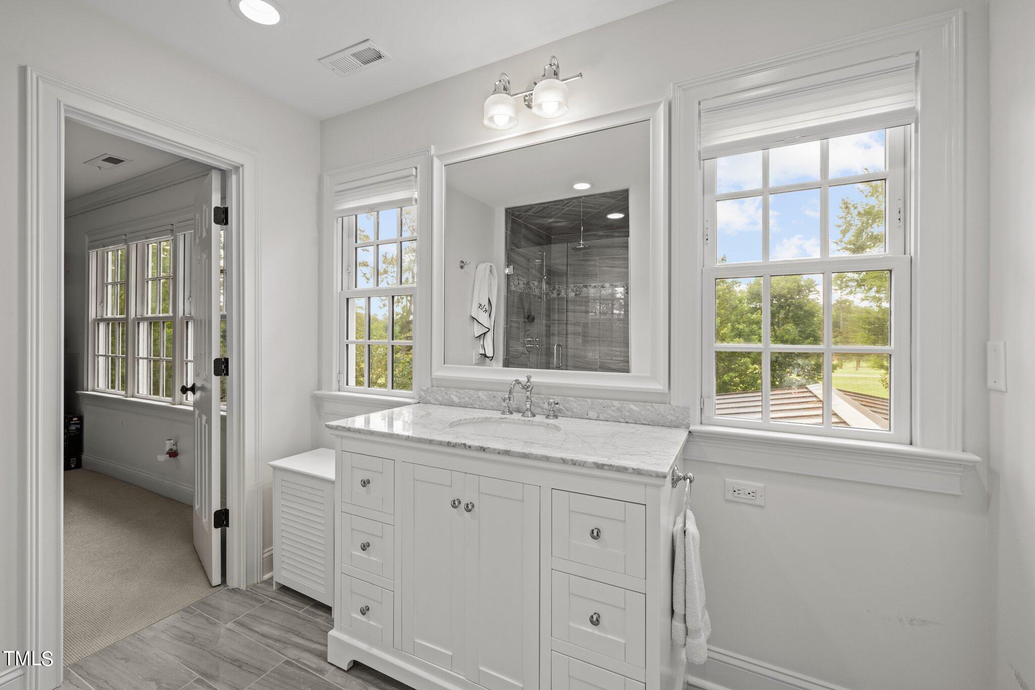 3125 Cornwall Road Durham, NC 27707 - Photo 67 of 99 a bathroom with a granite countertop sink mirror and window