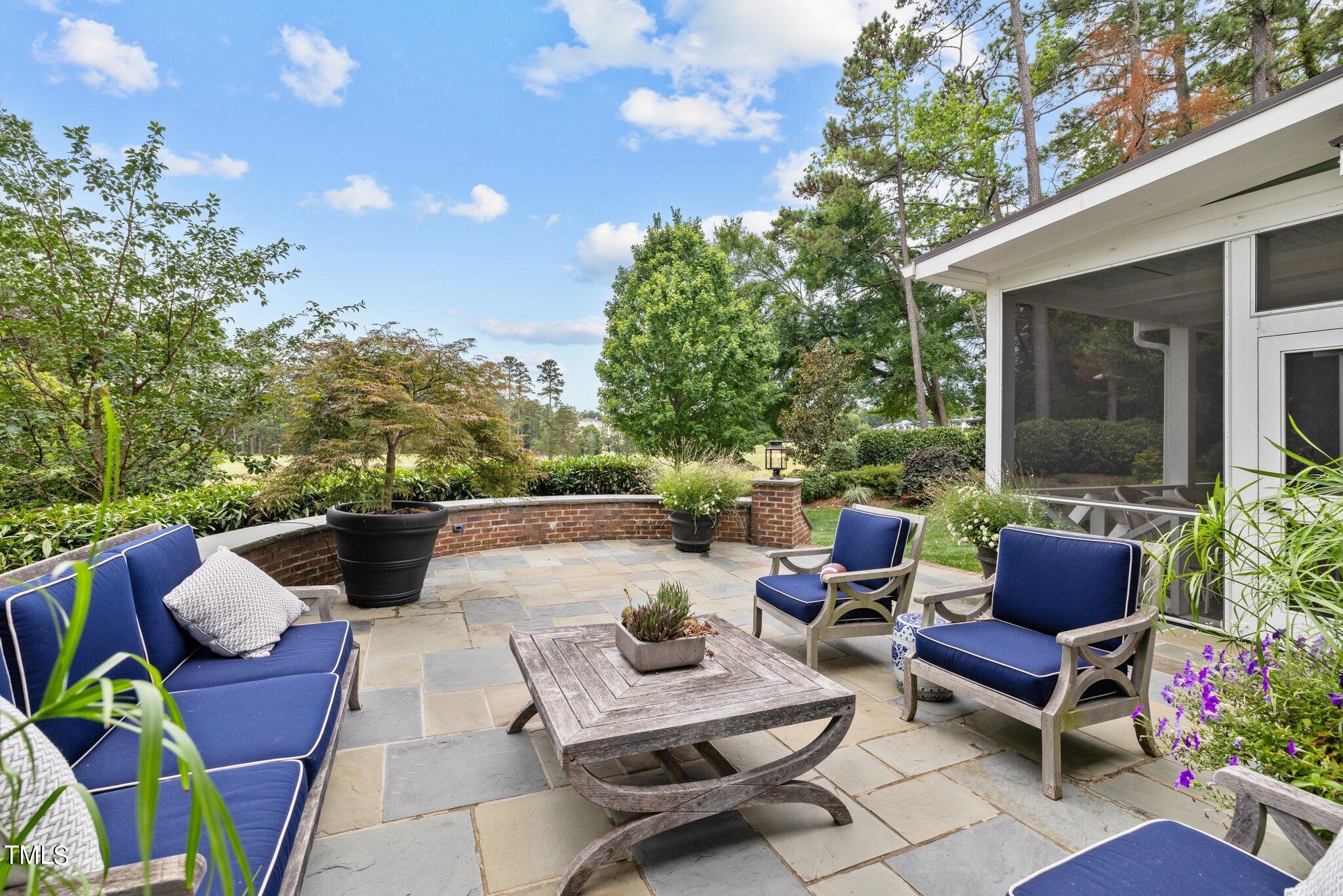 3125 Cornwall Road Durham, NC 27707 - Photo 82 of 99 a view of a patio with couches potted plants and a large tree