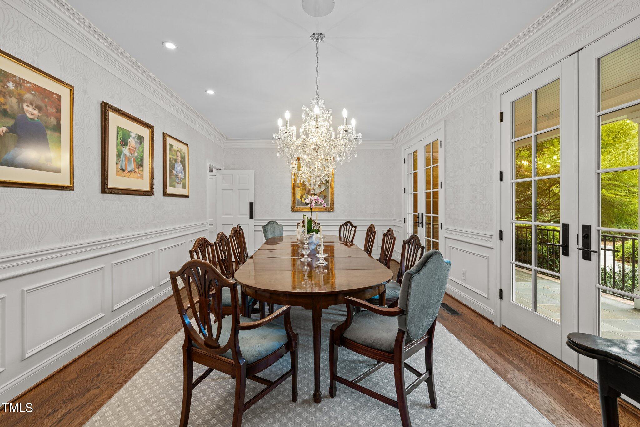 3125 Cornwall Road Durham, NC 27707 - Photo 9 of 99 a dining room with furniture a chandelier and wooden floor