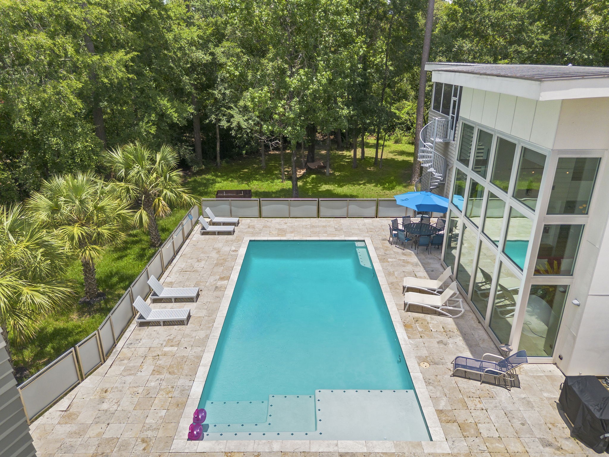 118 Angel Leaf Road The Woodlands, TX 77380 - Photo 37 of 50 Crystal-clear pool surrounded by nature, ideal for summer enjoyment.