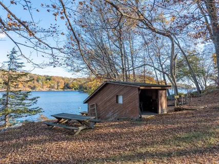 an aerial view of house with yard and outdoor seating