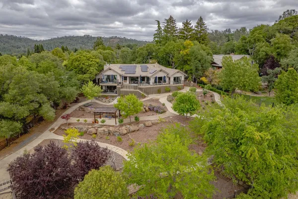 an aerial view of a house with a big yard