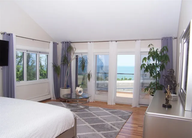 a bedroom with a bed and a potted plant