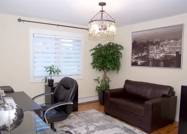 a living room with furniture flowers and a chandelier