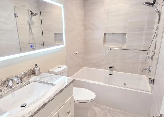 a bathroom with a sink a toilet and bathtub
