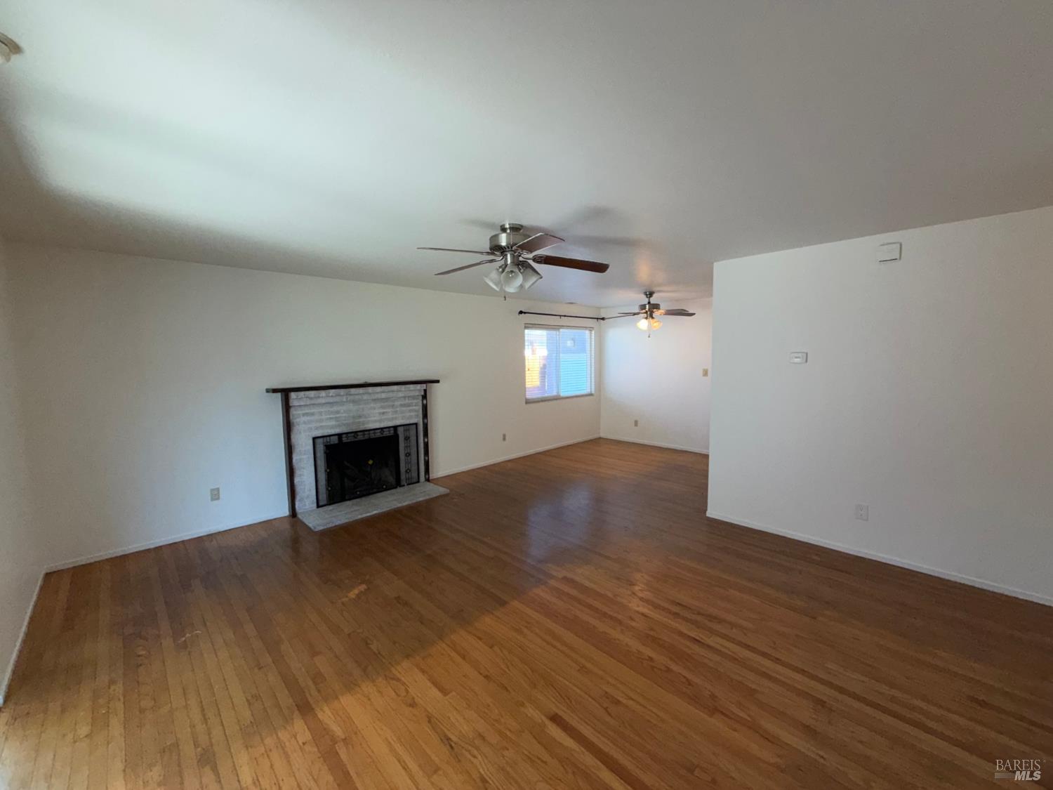 991 Rolling Green Drive Rio Vista, CA 94571 - Photo 13 of 30 a view of empty room with wooden floor and fireplace