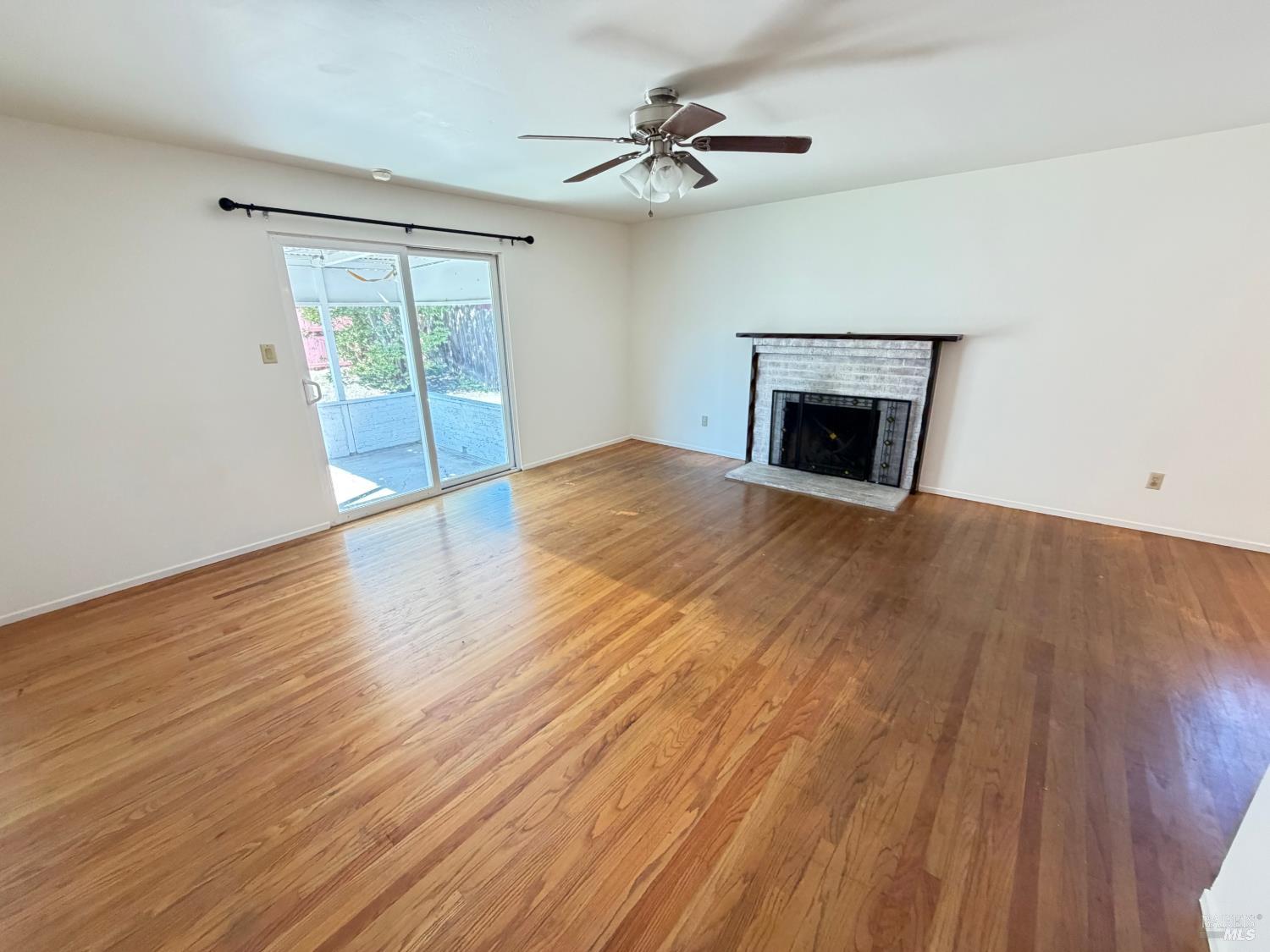 991 Rolling Green Drive Rio Vista, CA 94571 - Photo 14 of 30 wooden floor fireplace and windows in an empty room