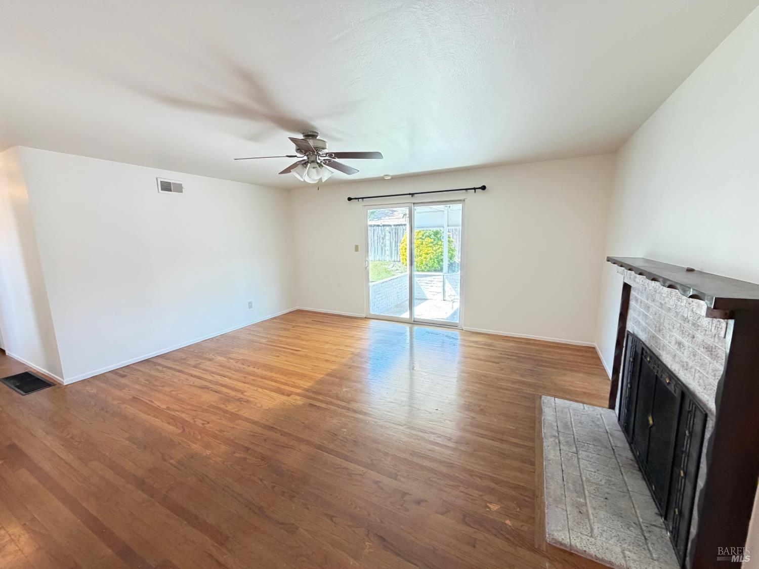 991 Rolling Green Drive Rio Vista, CA 94571 - Photo 16 of 30 a view of an empty room with a fireplace and a window