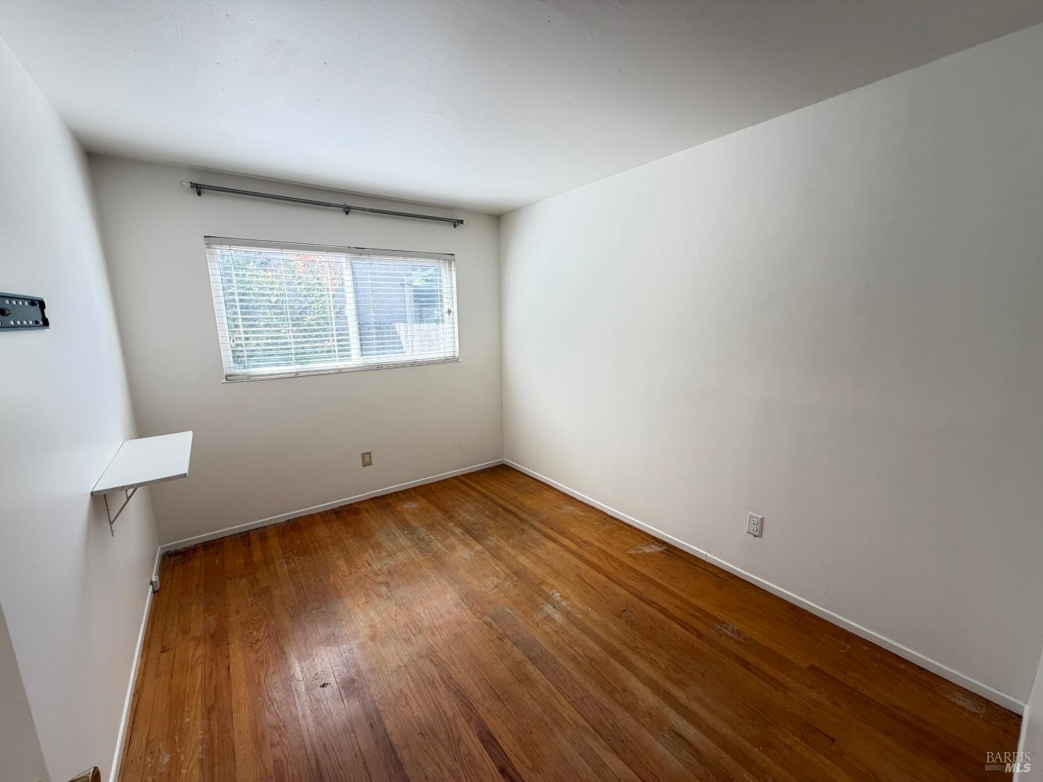 991 Rolling Green Drive Rio Vista, CA 94571 - Photo 19 of 30 an empty room with wooden floor and windows