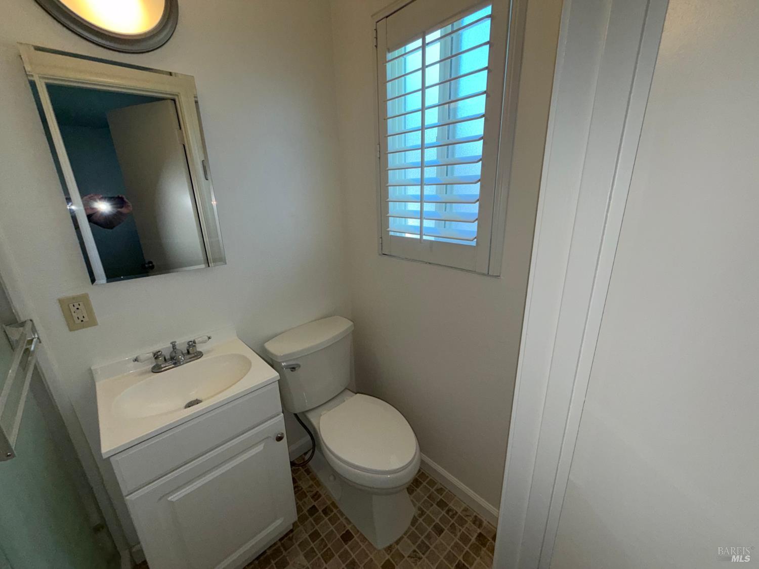 991 Rolling Green Drive Rio Vista, CA 94571 - Photo 23 of 30 a white toilet sitting next to a bathroom sink