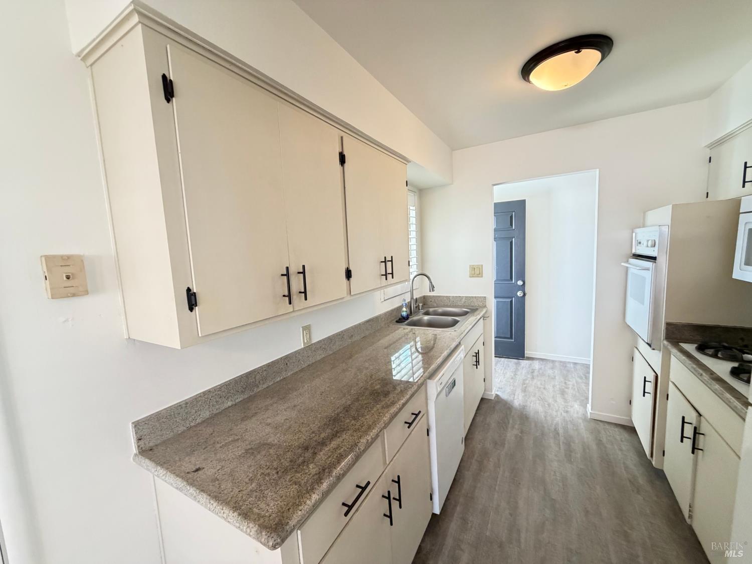 991 Rolling Green Drive Rio Vista, CA 94571 - Photo 7 of 30 a large kitchen with a center island wooden floor and stainless steel appliances