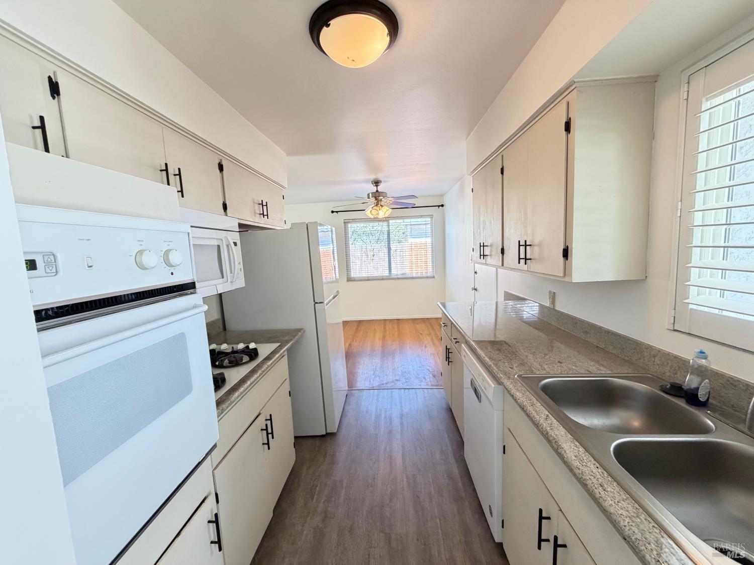 991 Rolling Green Drive Rio Vista, CA 94571 - Photo 10 of 30 a kitchen with granite countertop a sink dishwasher stove and refrigerator