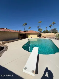 a view of a swimming pool with an outdoor seating
