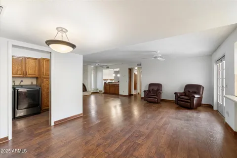 a view of a livingroom with furniture a ceiling fan and window