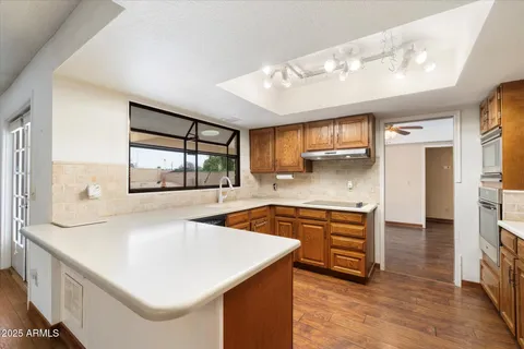 a kitchen with stainless steel appliances granite countertop a sink and a stove