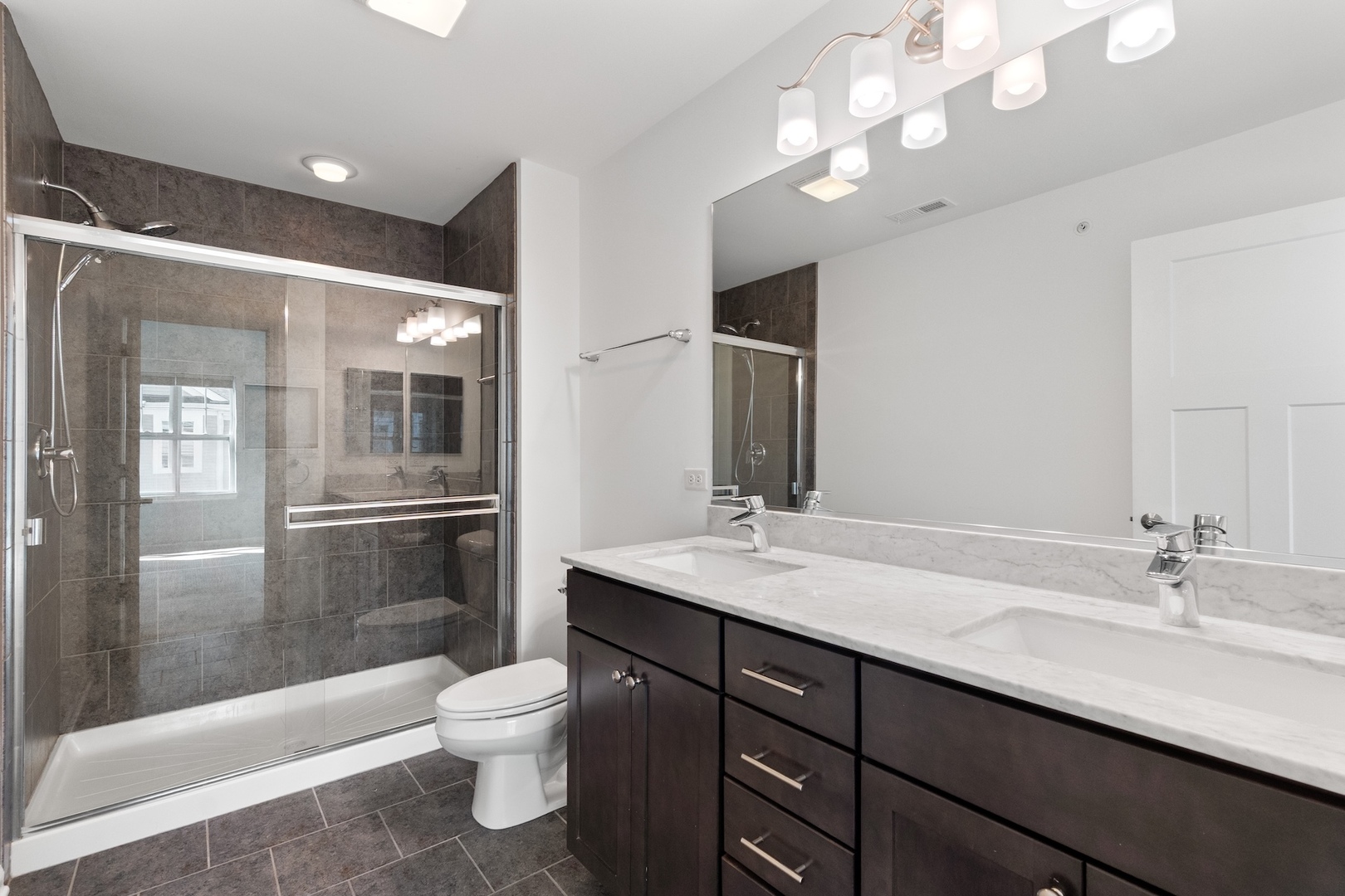 1228 Elm Street Park Ridge, IL 60068 - Photo 18 of 36 a bathroom with a granite countertop sink a toilet a mirror and shower