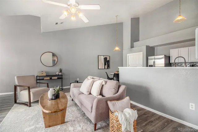 a living room with furniture and a chandelier