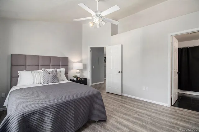 a bedroom with a large bed chandelier and a closet