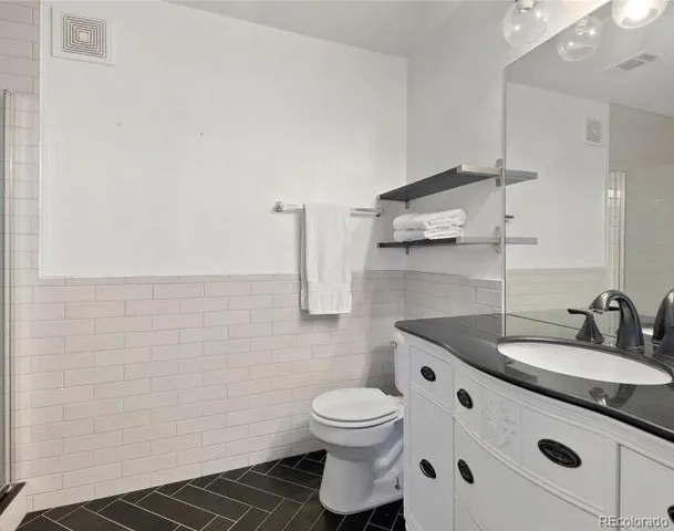 a bathroom with a sink toilet and vanity