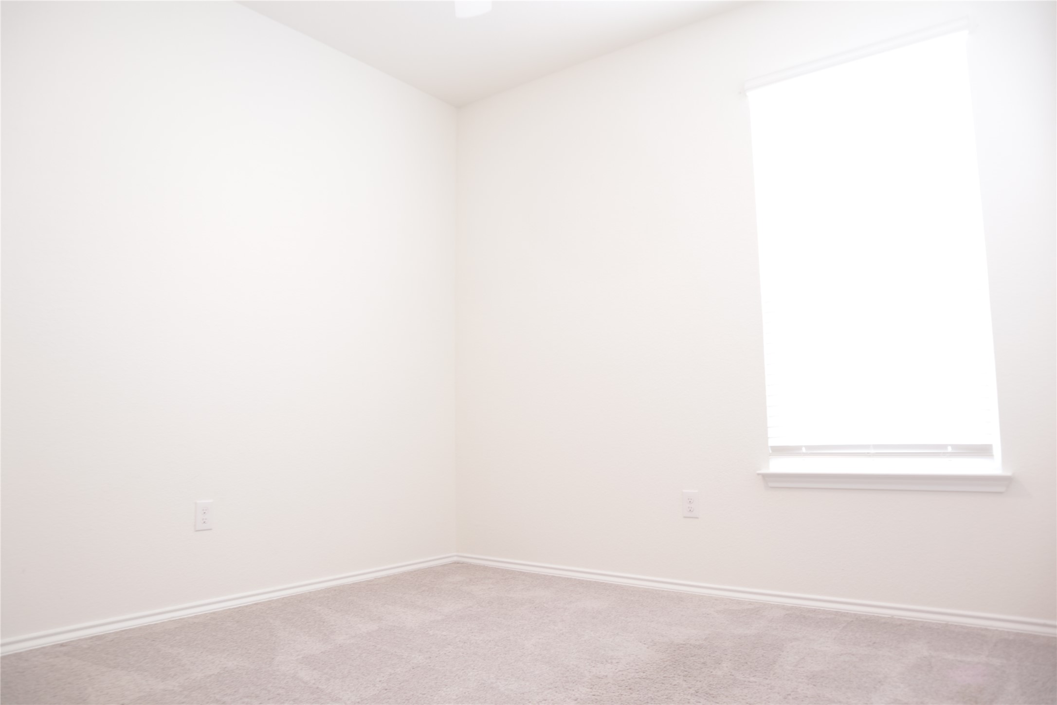 8111 Marigny Way Austin, TX 78744 - Photo 8 of 29 A well-lit, neutral room with fresh carpet and a prominent window.
