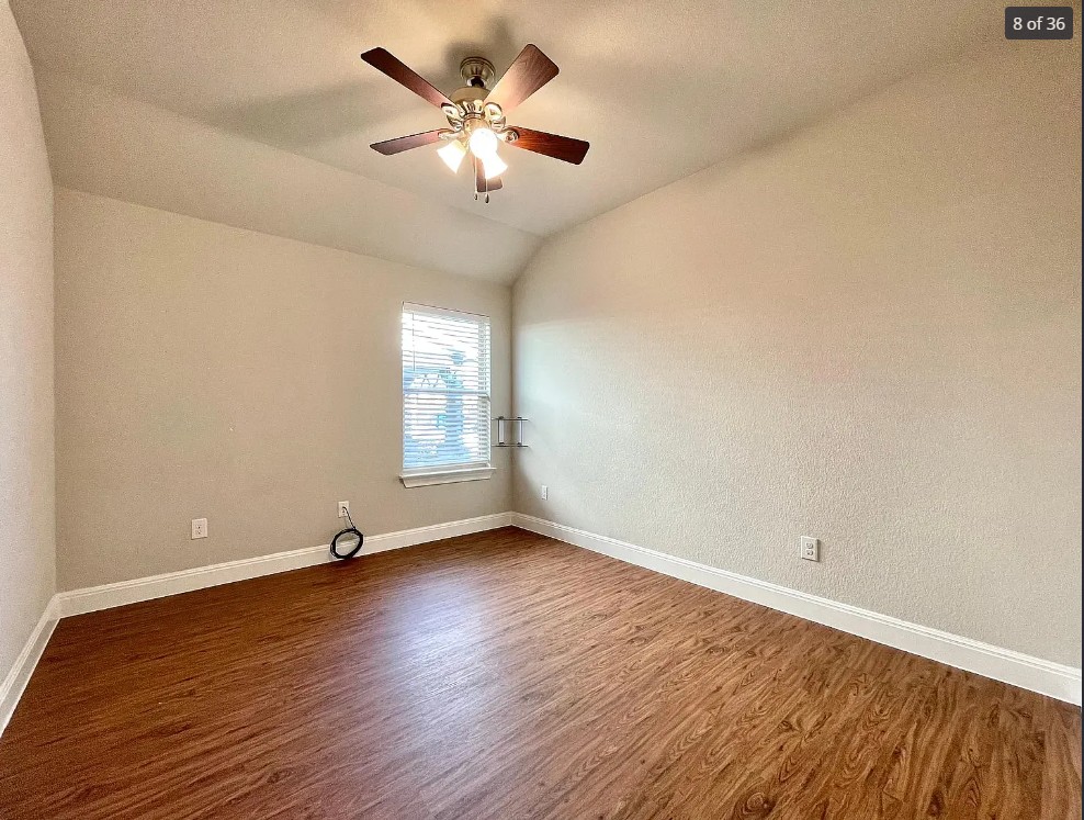 205 Jude Circle Leander, TX 78641 - Photo 11 of 36 an empty room with wooden floor and windows
